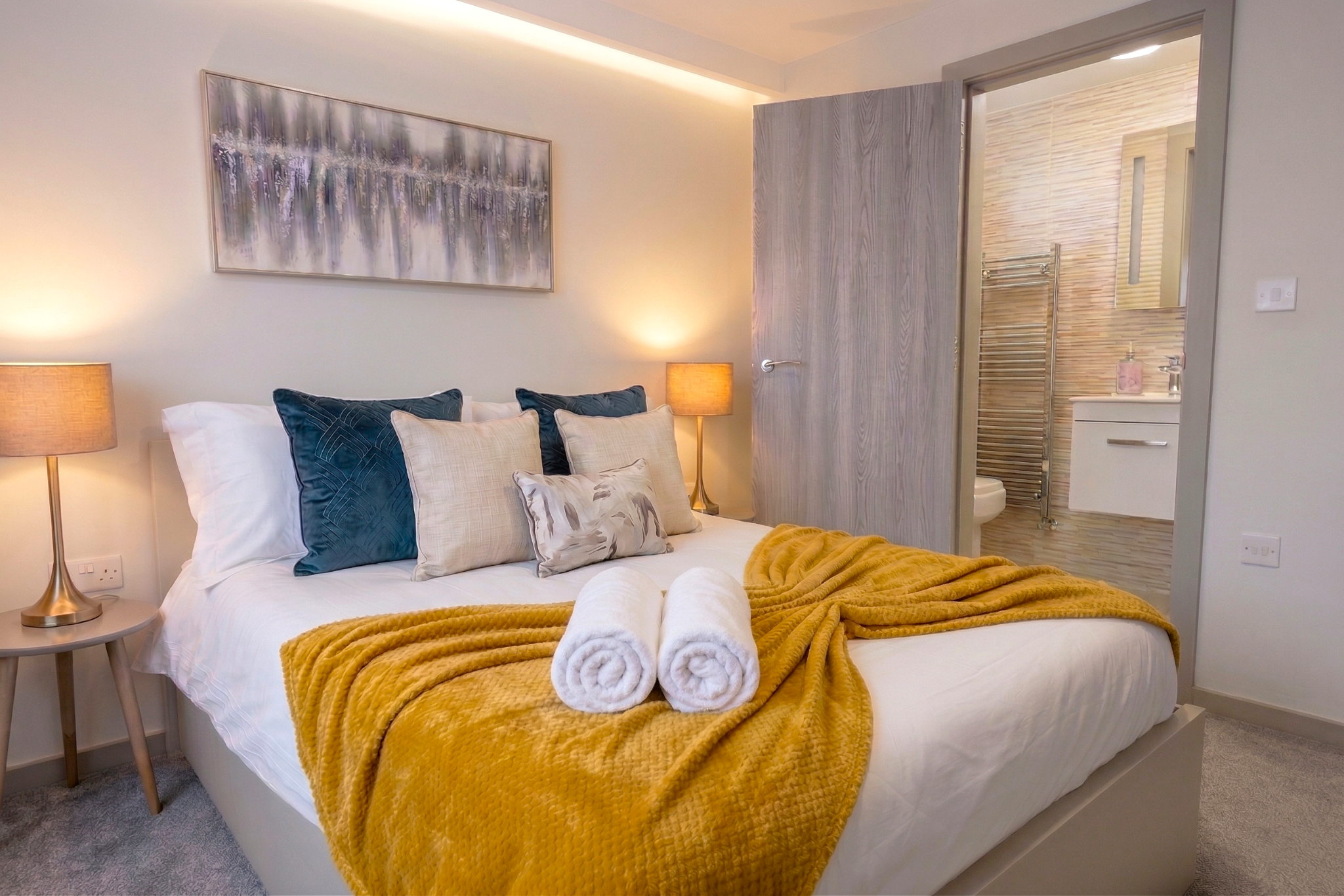 Bedroom with ensuite and warm mustard throw